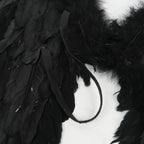 Close-up detail of black elastic straps on the back of black feather angel wings