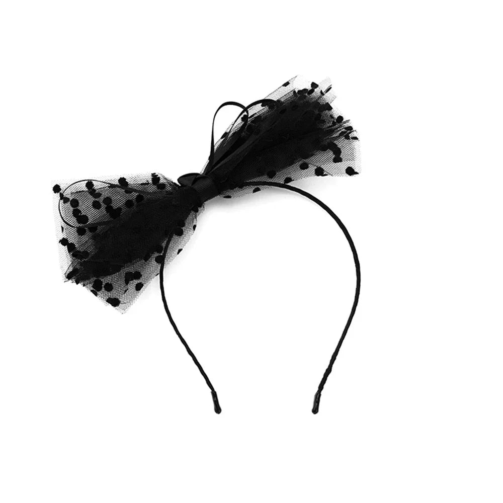 Black polka dot tulle bow headband, angled front view