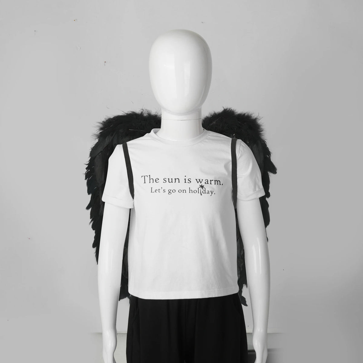 Black feather angel wings worn by mannequin, front wearing view