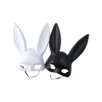 White and black matte bunny ear masquerade masks with straps, tilted front view