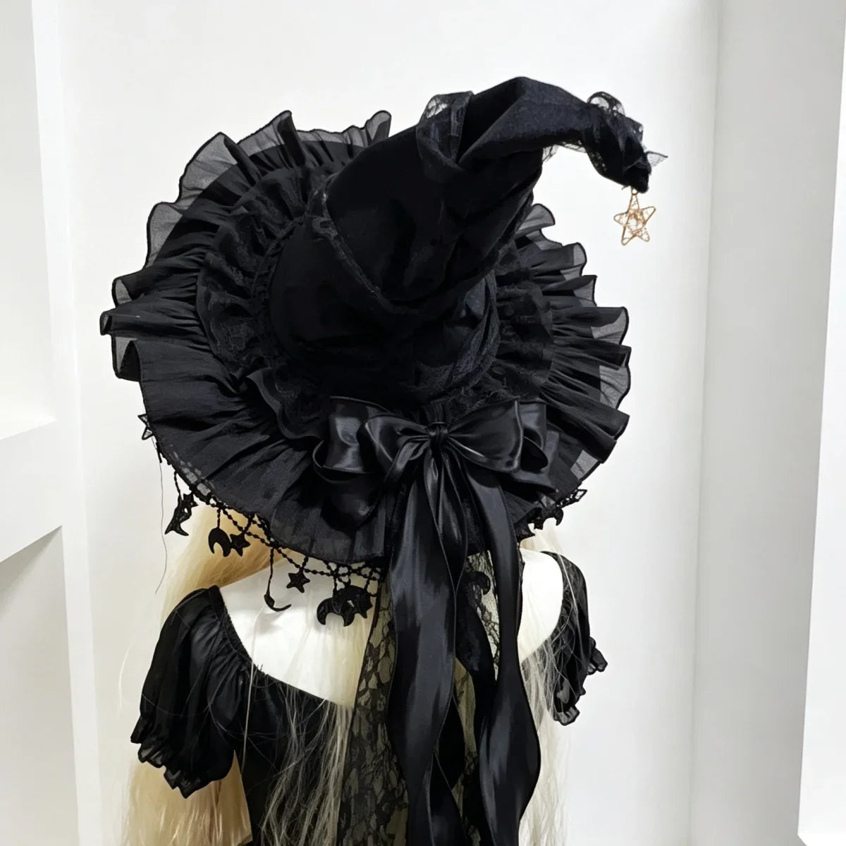 Black lace witch hat with black bow back view on model