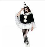 Model in black pierrot clown poncho with hat and striped tights, standing front view