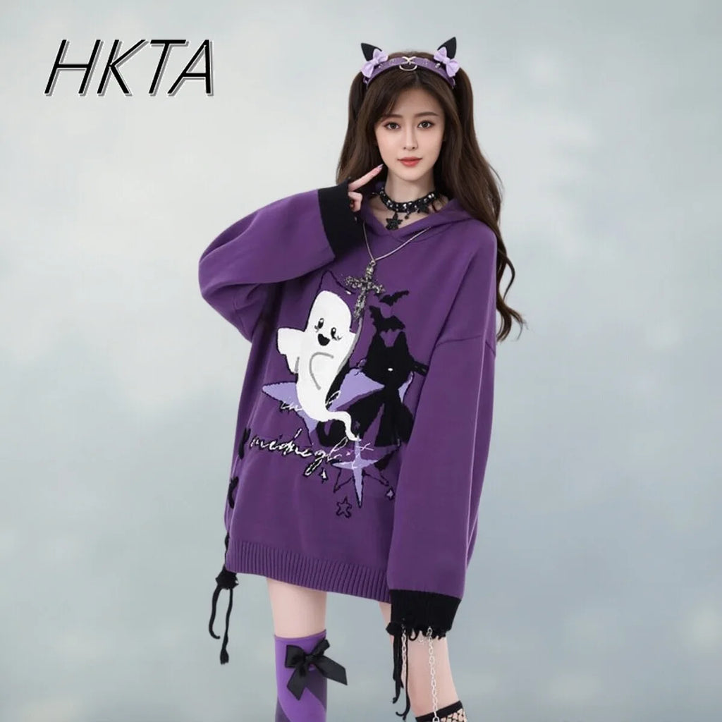 Model wearing purple ghost knit sweater with bat print, front view close-up
