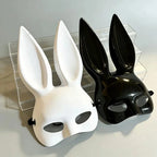 White and black glossy bunny ear masquerade masks displayed side by side