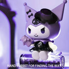 Kuromi Sanrio figure with tiny hat holding a hand puppet, close-up front view