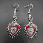 Pair of red evil eye heart earrings with silver rose, front flat lay