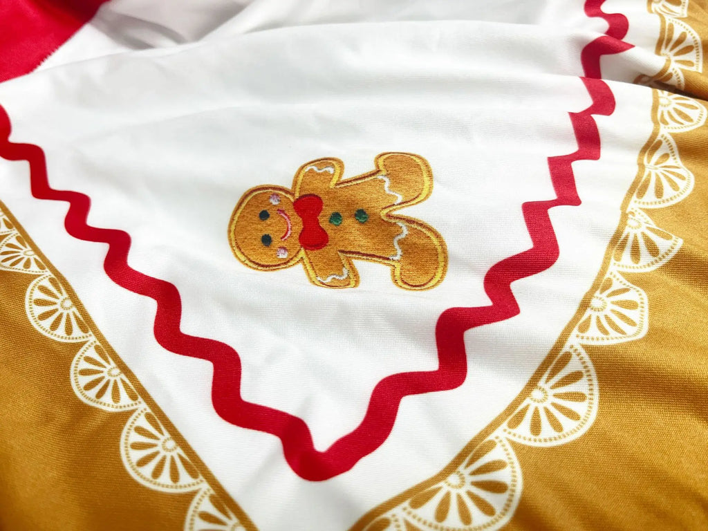 Gingerbread woman costume dress set worn with striped socks, full outfit view