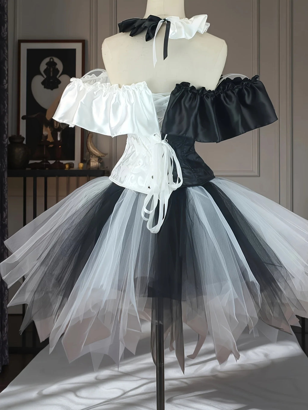 Black and white creepy clown costume back view on mannequin with back lacing detail