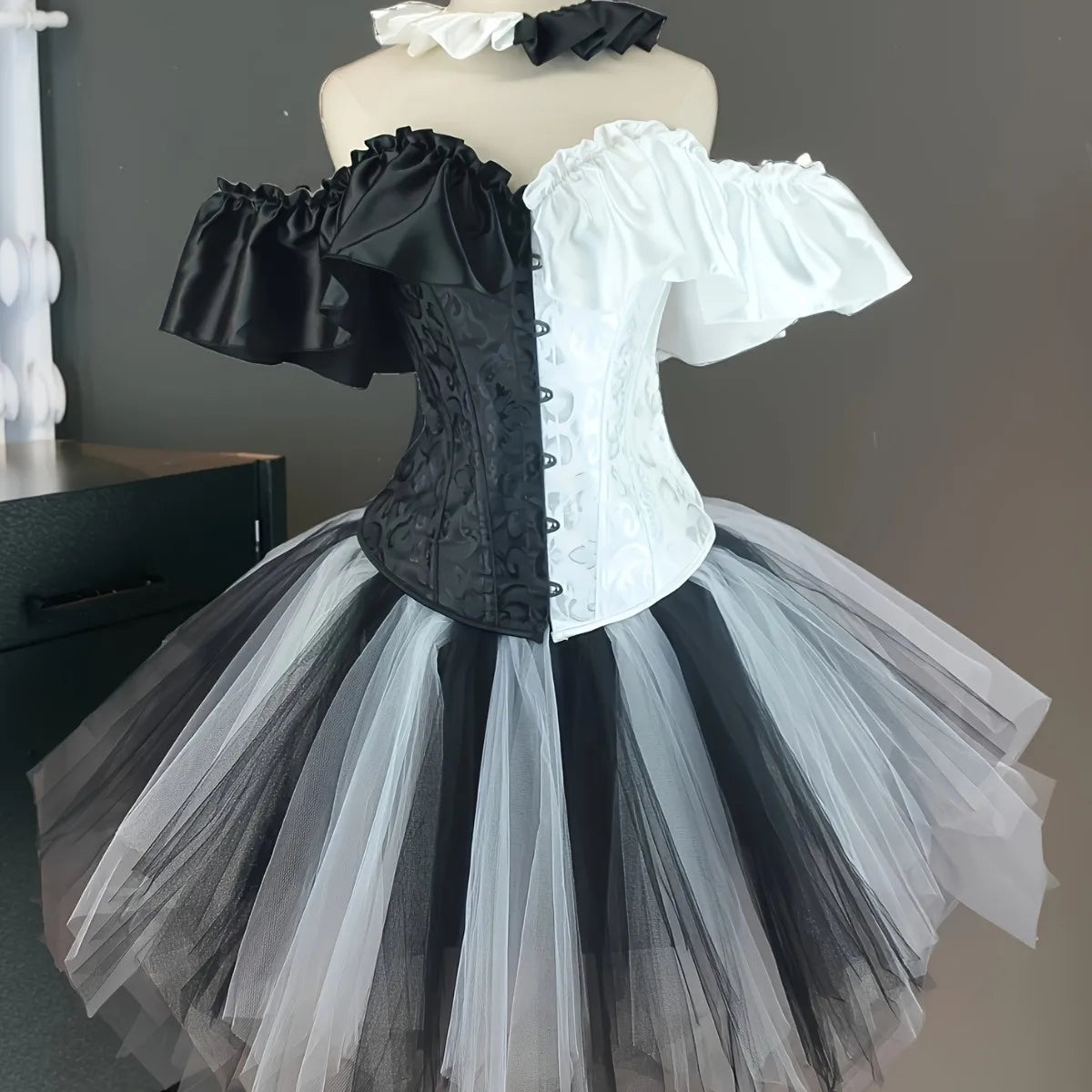 Black and white split creepy clown corset costume close front view on mannequin