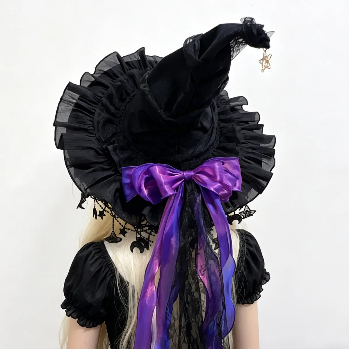 Black lace witch hat with purple bow back view on model