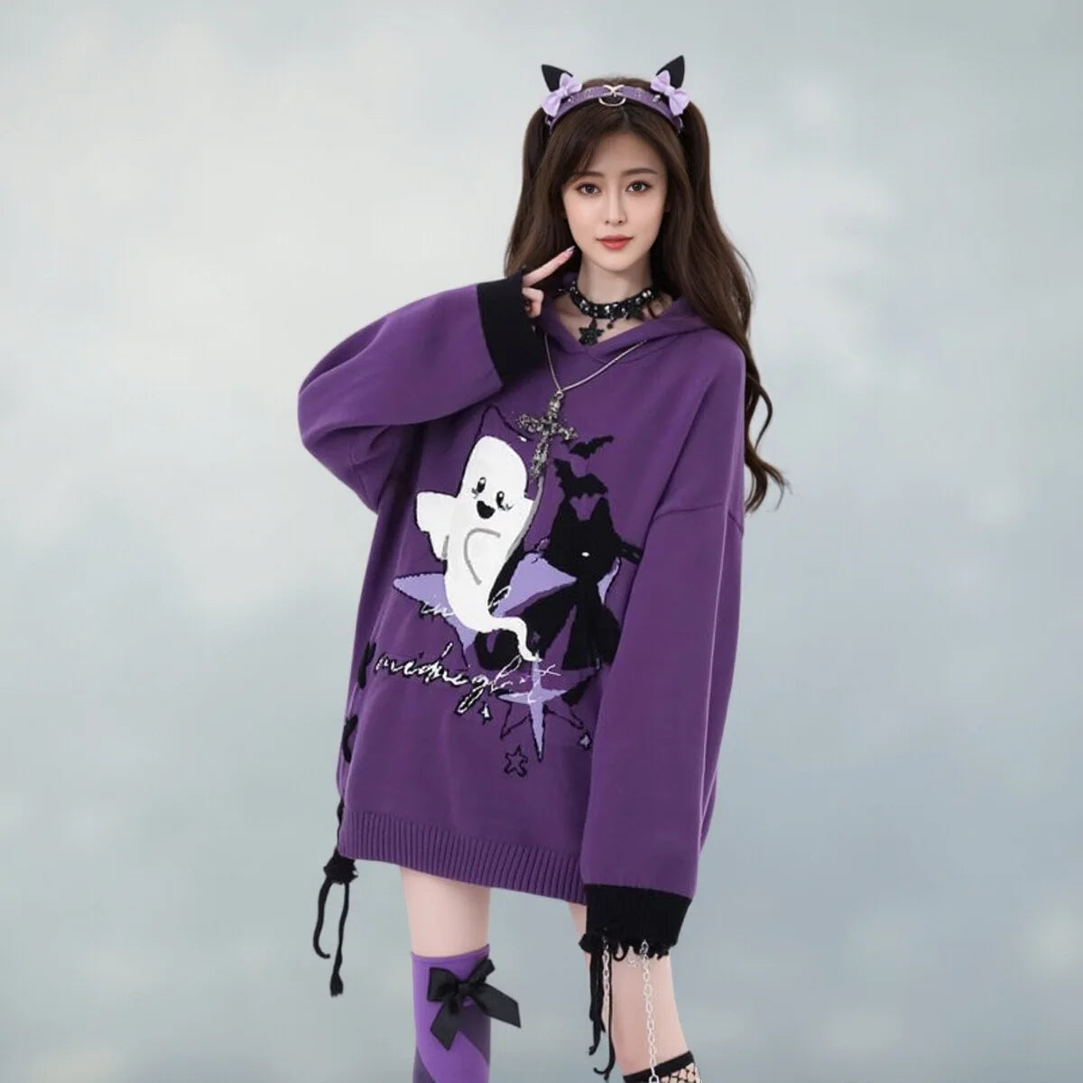 Model in purple Y2K ghost knit sweater with cat ear headband, front view
