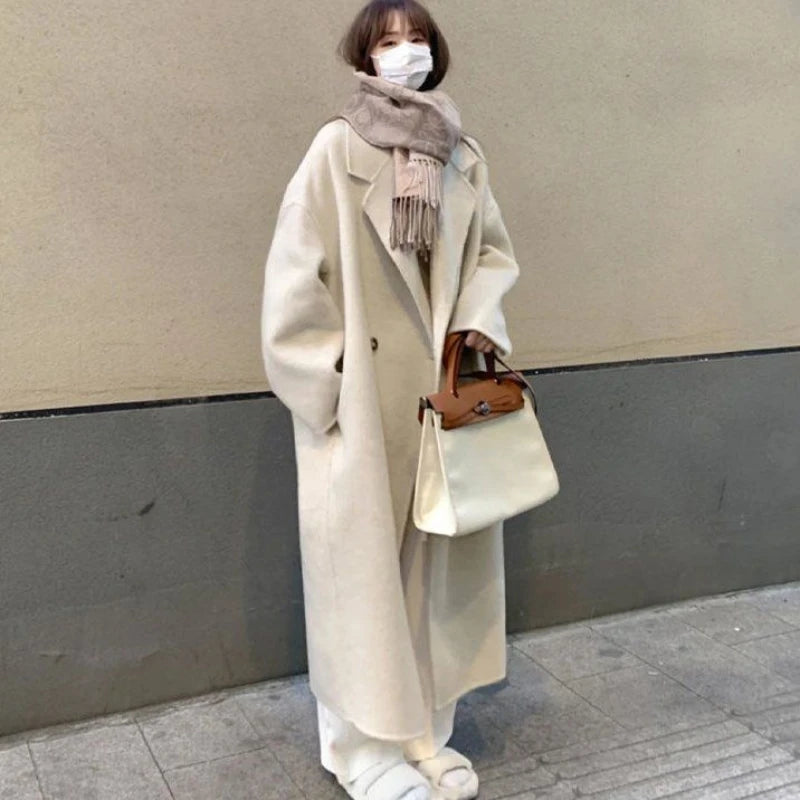 Cream Wool Coat Sweater and Wide Leg Jeans Set, model styling the long cream wool coat with scarf and handbag