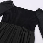 Close up of square neckline and sheer bell sleeve detail on black witch dress