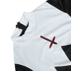 Close-up detail of white nun collar with red cross print and zipper