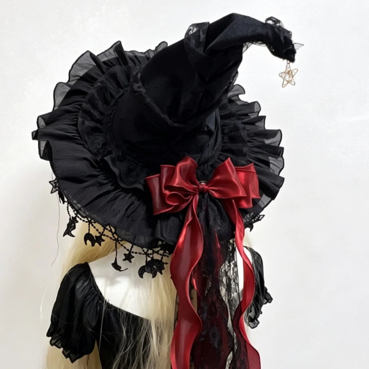 Black lace witch hat with red bow back view on model