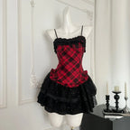 Red plaid lace trim corset with black ruffled mini skirt on mannequin, front view