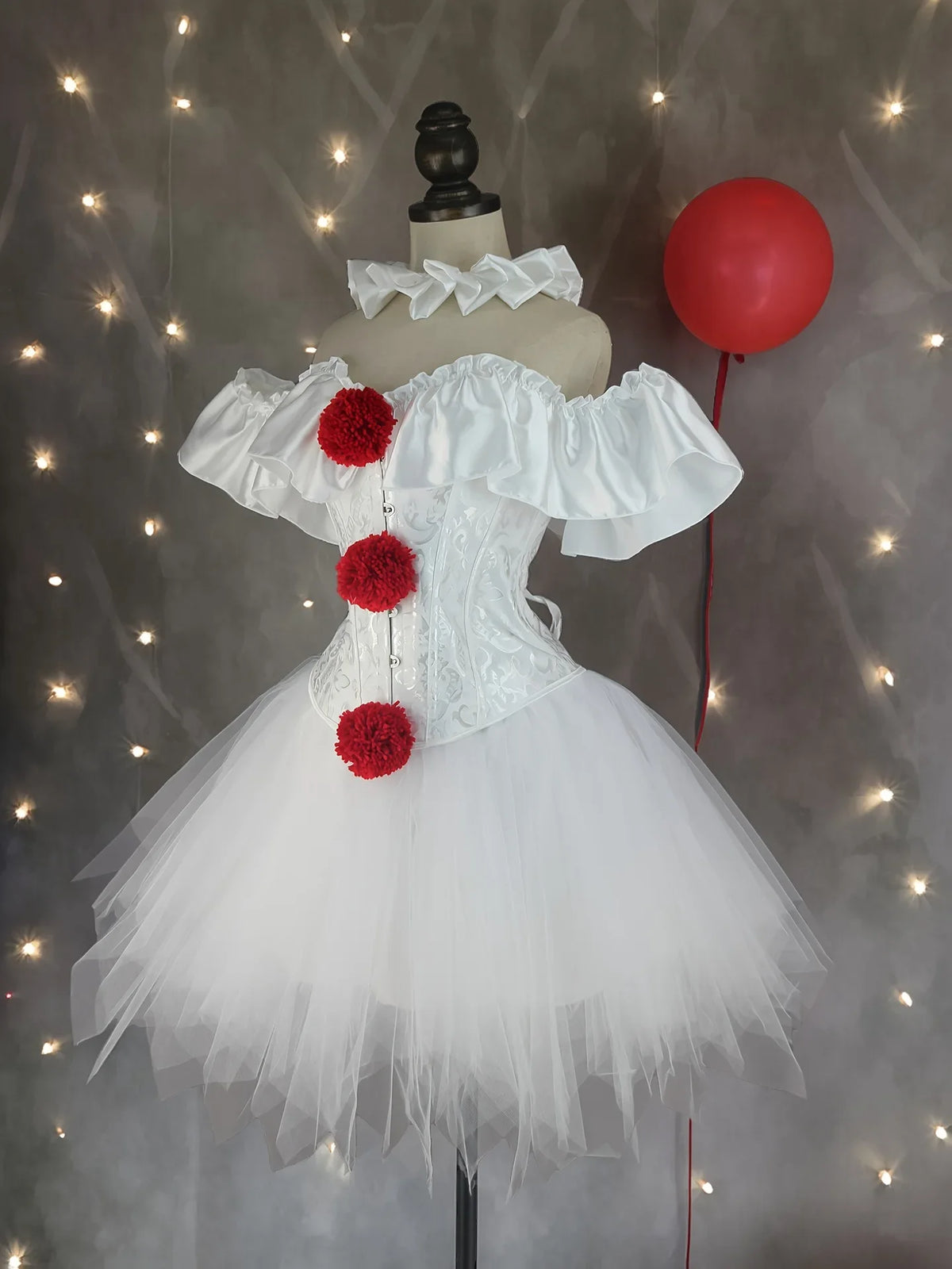 White creepy clown corset costume front view on mannequin with red pom poms and balloon