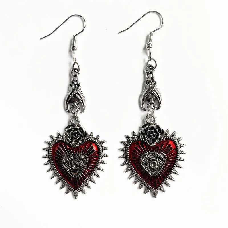 Gothic red heart evil eye earrings with silver rose tops, front view