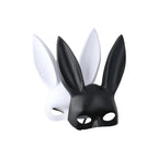 Black matte bunny ear mask in front of white mask, angled view