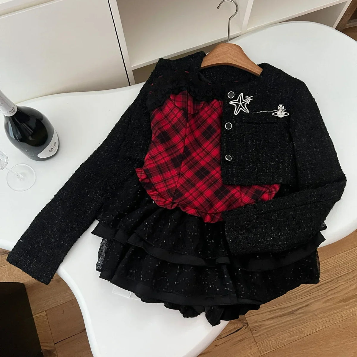 Red plaid corset and skirt set with tweed jacket flat lay on hanger