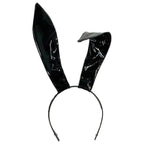 Shiny black rabbit ear headband with one bent ear, front view on white background