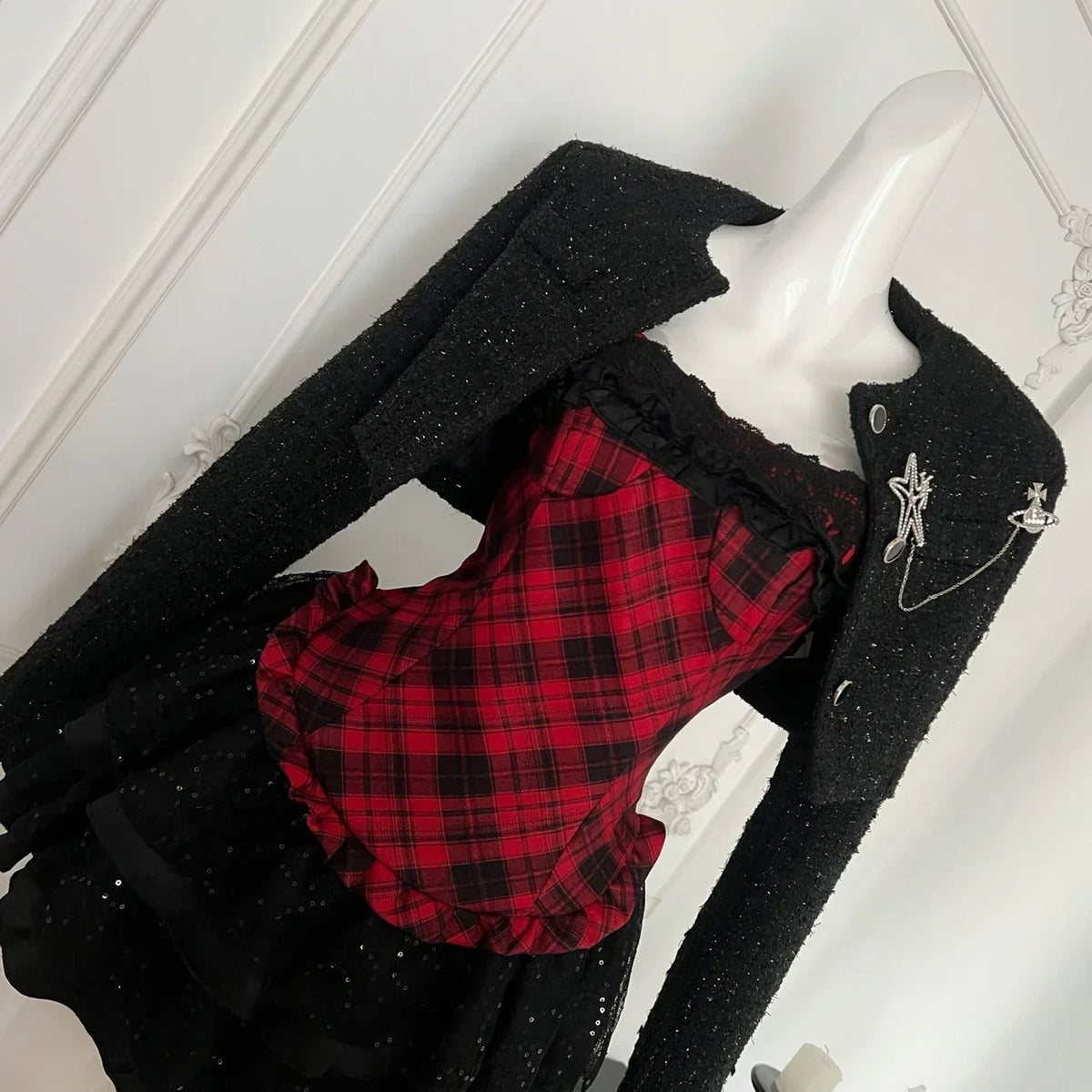 Red plaid corset skirt set with tweed jacket on mannequin, angled front view