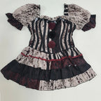 Bloody clown striped jester dress with red pom poms, flat lay front view