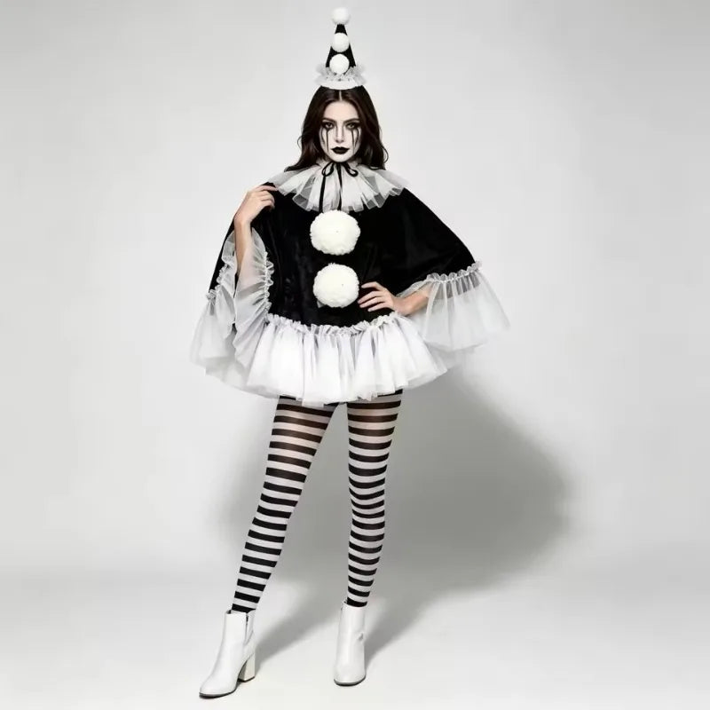 Model in black pierrot poncho with pom pom hat and striped tights, full front view
