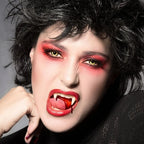 Model wearing white vampire teeth fangs, close up smile