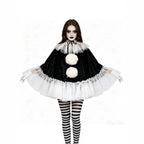 Model with arms spread showing black velvet pierrot poncho with white tulle ruffle