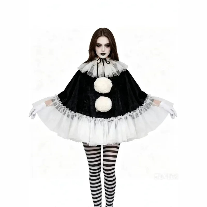 Model with arms spread showing black velvet pierrot poncho with white tulle ruffle