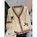 Cream cable knit cardigan with shirt tie and pleated skirt, necktie detail