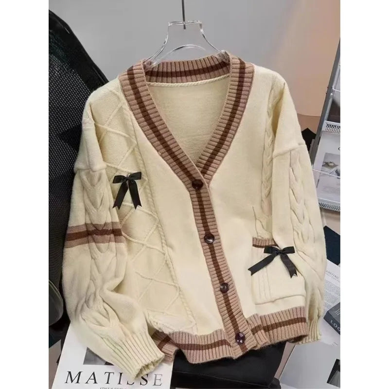 Cream cable knit cardigan with shirt tie and pleated skirt, necktie detail