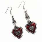 Gothic red heart evil eye earrings with rose and bat details, angled view