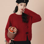 Woman wearing a red college style loose pullover sweater holding a bouquet of flowers and wearing a black beret