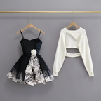 Black floral sling dress and white cropped wrap top on separate hangers