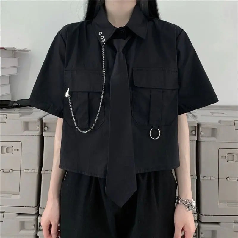 Black two piece punk dress outfit with short sleeve shirt, tie, metal chain, and rings