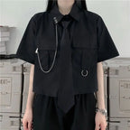 Black two piece punk dress outfit with short sleeve shirt, tie, metal chain, and rings
