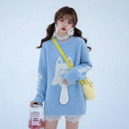 Japanese cute cat print pullover sweater in light blue fuzzy fabric worn outdoors in snowy setting