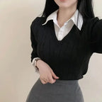 Black cable knit sweater layered over white collared shirt casual knitwear for women styled with gray skirt