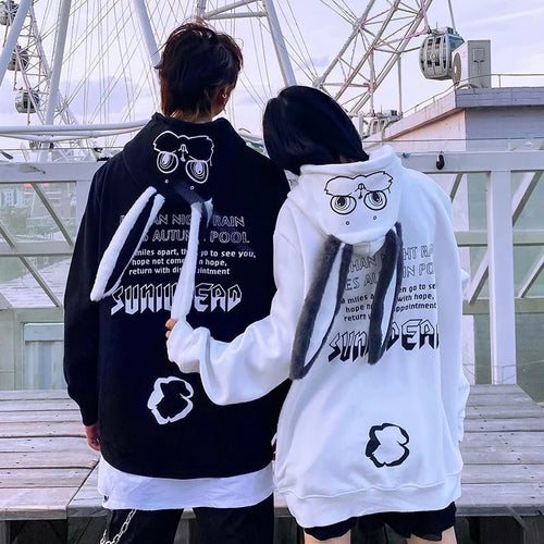 Couple wearing cute animal couple hoodie for teens with bunny ears and graphic text on back
