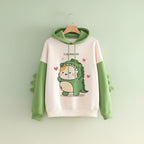 Cute cartoon dinosaur sweatshirt unisex with green hood and sleeves featuring dinosaur spikes and heart accents