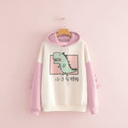 Cute dinosaur hoodie for winter with pink sleeves and dinosaur spikes on the arms