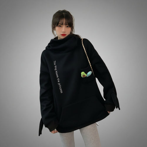 Woman wearing black cute frog pullover sweatshirt with frog and bird embroidery and high neck