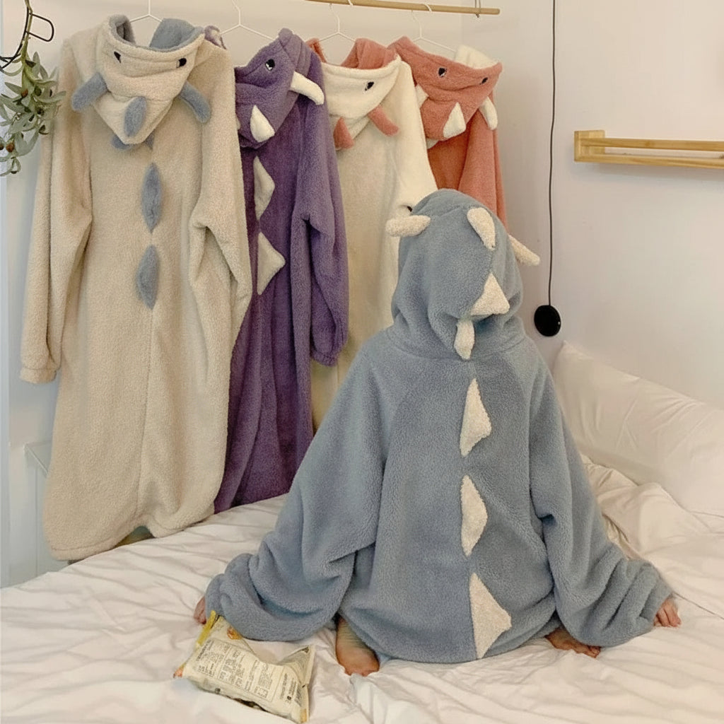 Cute hooded pajamas for women in dinosaur style with soft fabric in multiple colors displayed on hangers and worn by a person