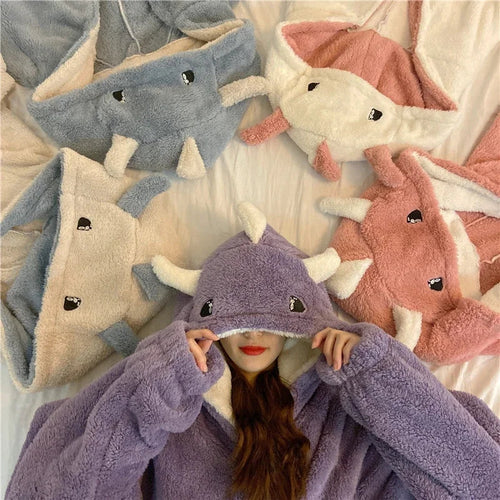 Woman wearing purple cute hooded pajamas for women with plush dinosaur design and multiple color options