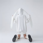 Back view of a woman wearing a cute hooded rabbit cardigan for women with long ears and a pom pom tail