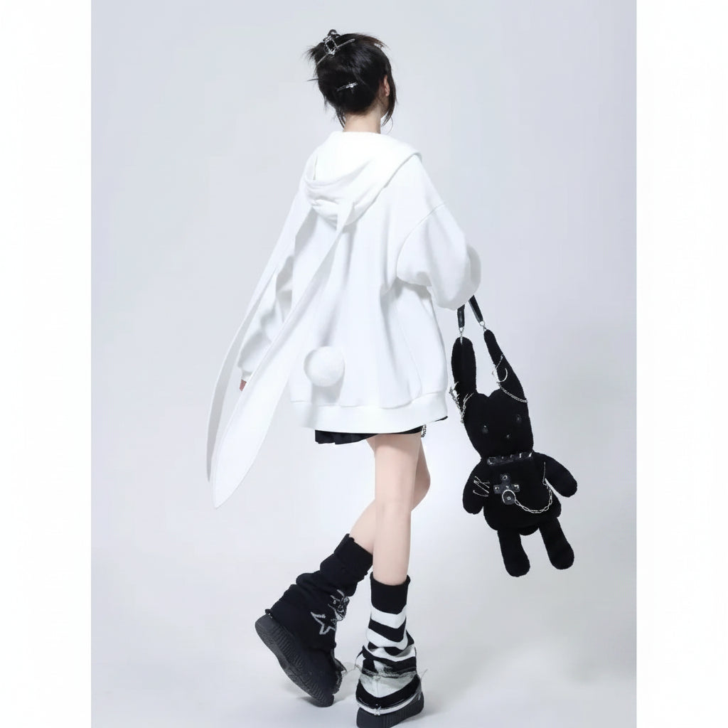 Woman wearing a cute hooded rabbit cardigan for women in white with long bunny ears detail