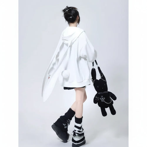 Woman wearing a cute hooded rabbit cardigan for women in white with long bunny ears detail