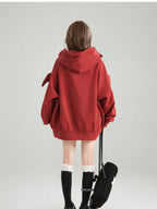 Cute oversized kawaii hoodie for girls in red worn by a model shown from the back with a large hood
